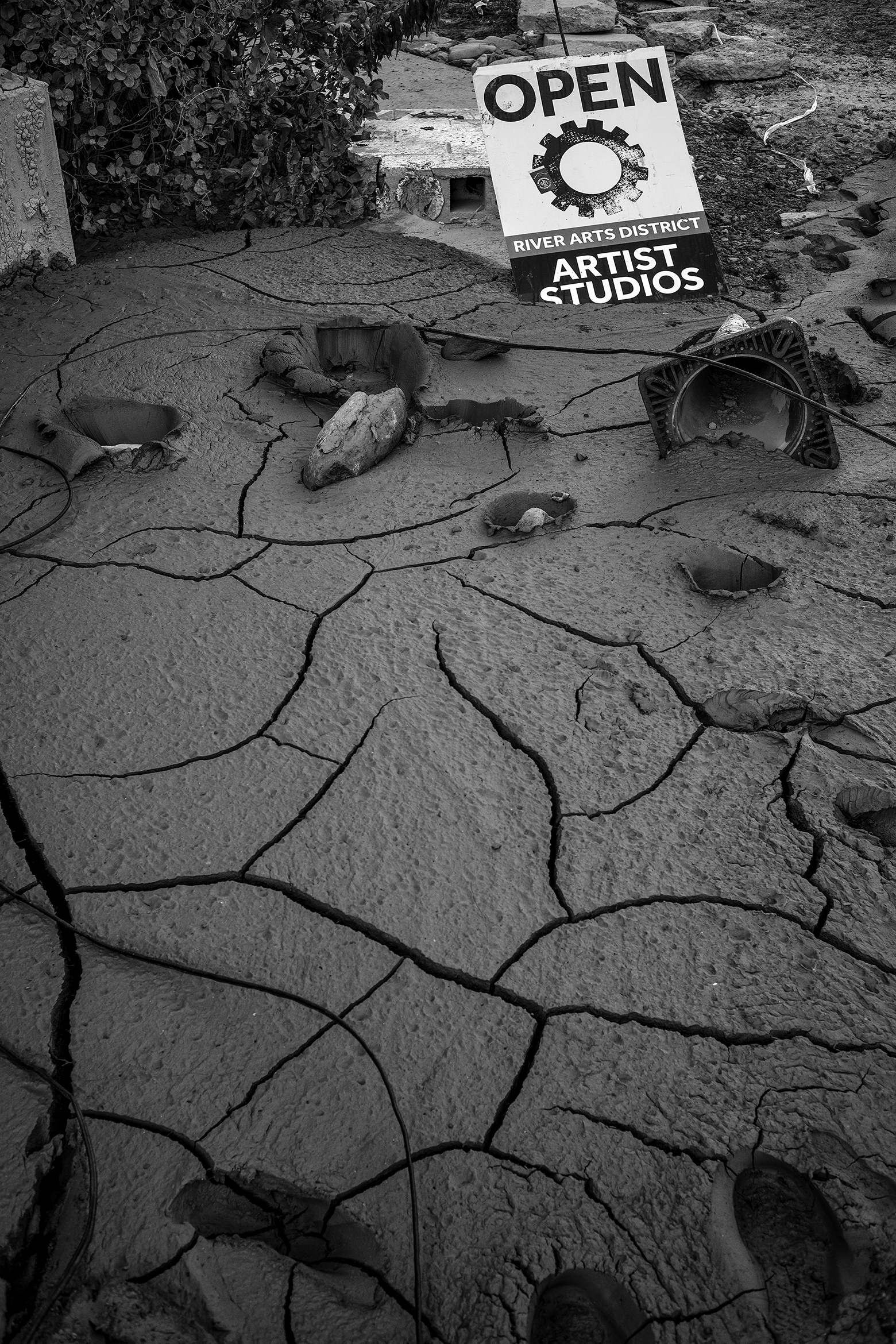 Artist Studio sign sits in cracked mud.