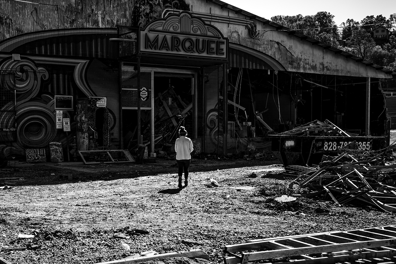 Woman walks toward Marquee building.