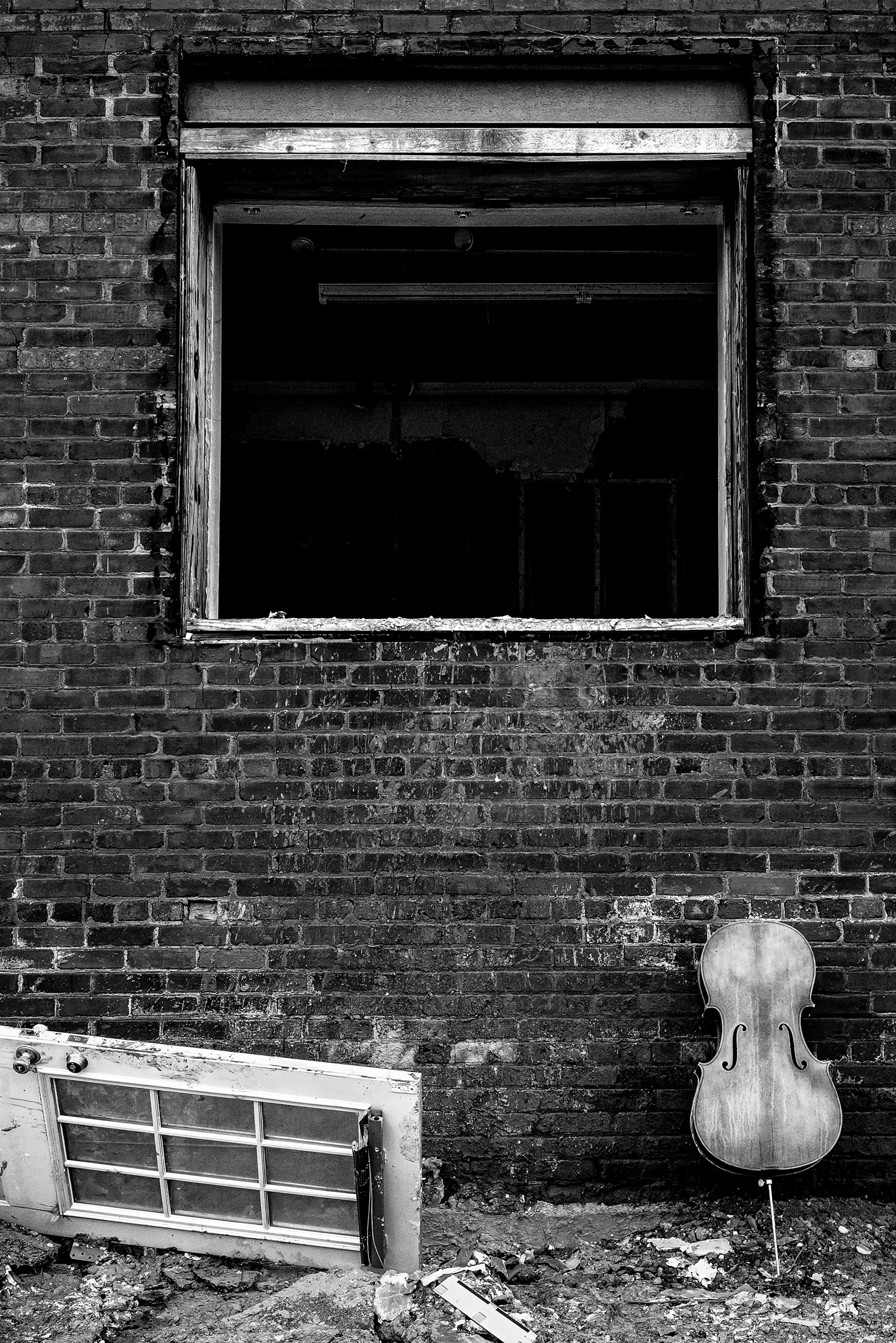 Cello and door debris outside a window