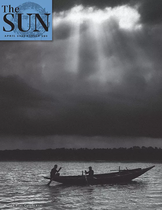 Two men fishing from a boat on a river as sunbeams come through clouds