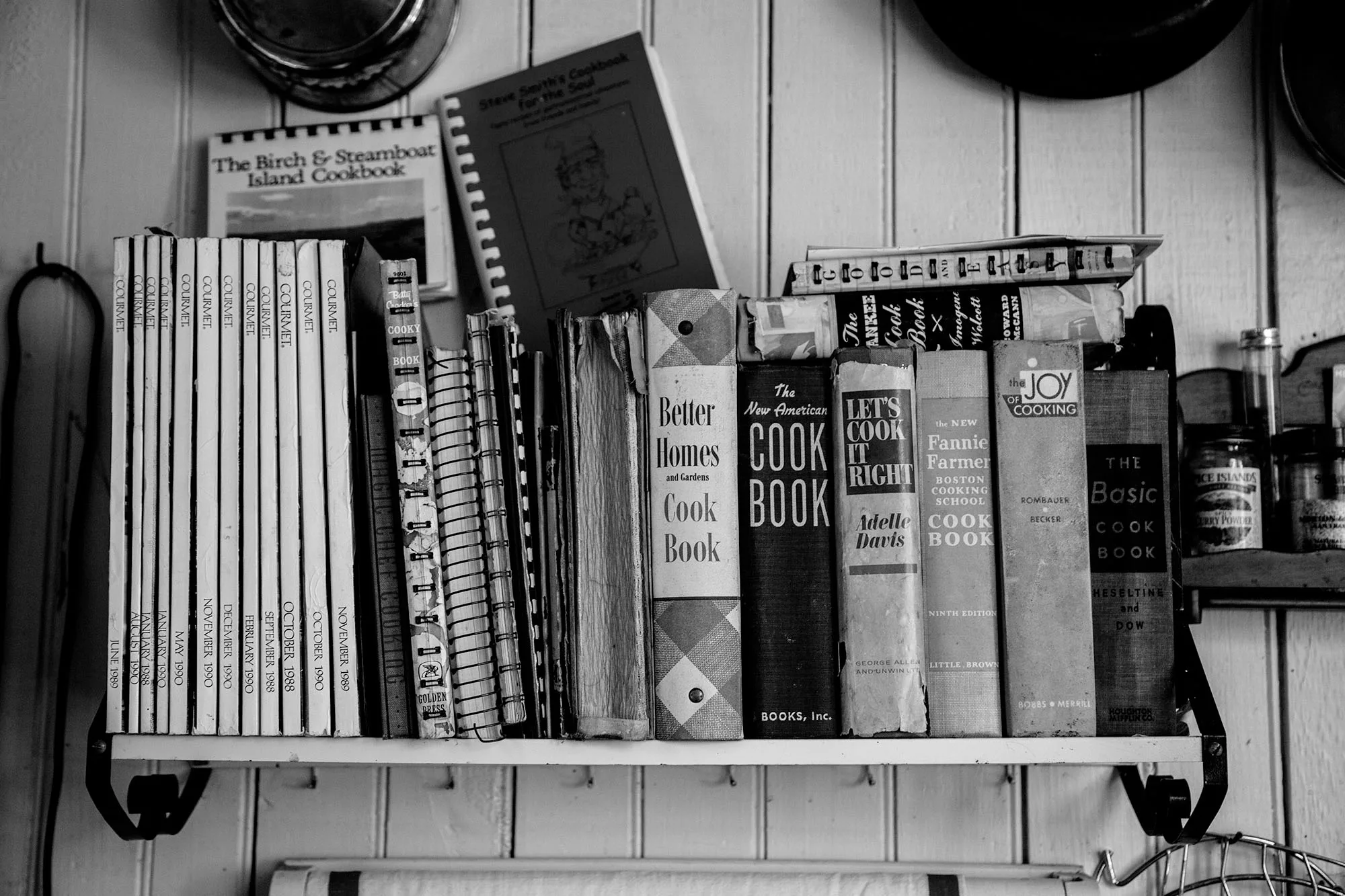 Kitchen shelf with vintage cookbook collection. Featured image for "Start with Overripe Bananas" by Sara Spurgeon.
