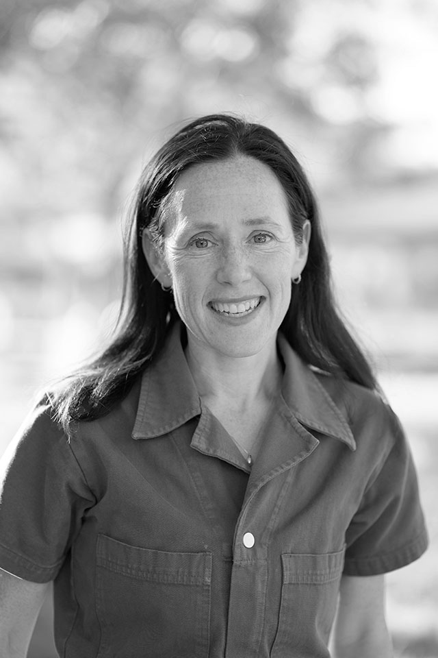 Portrait of Lily Geismer, author and historian, smiling outdoors. Photo by Anibal Ortiz.