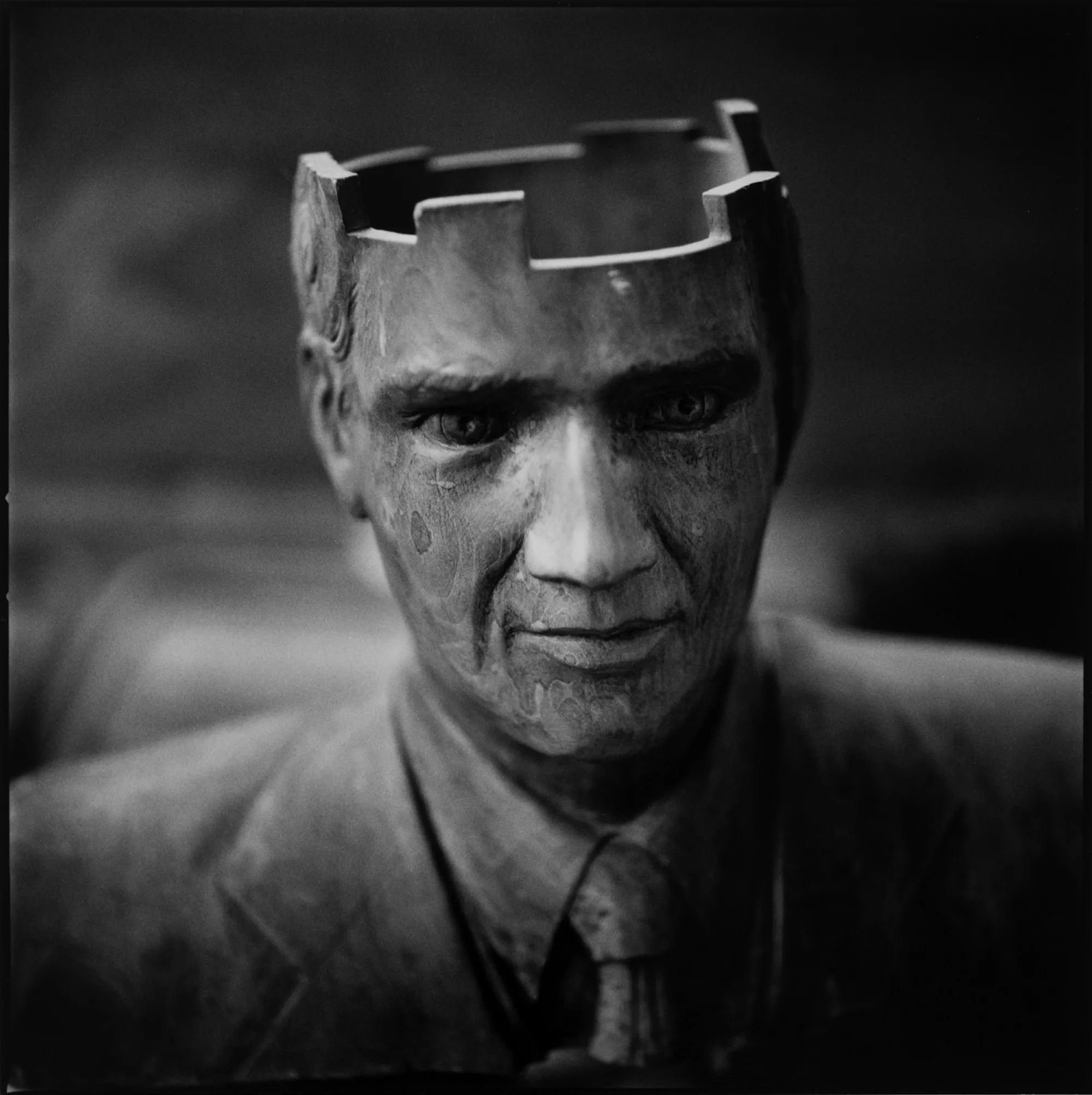 A male statue in a suit with an open head