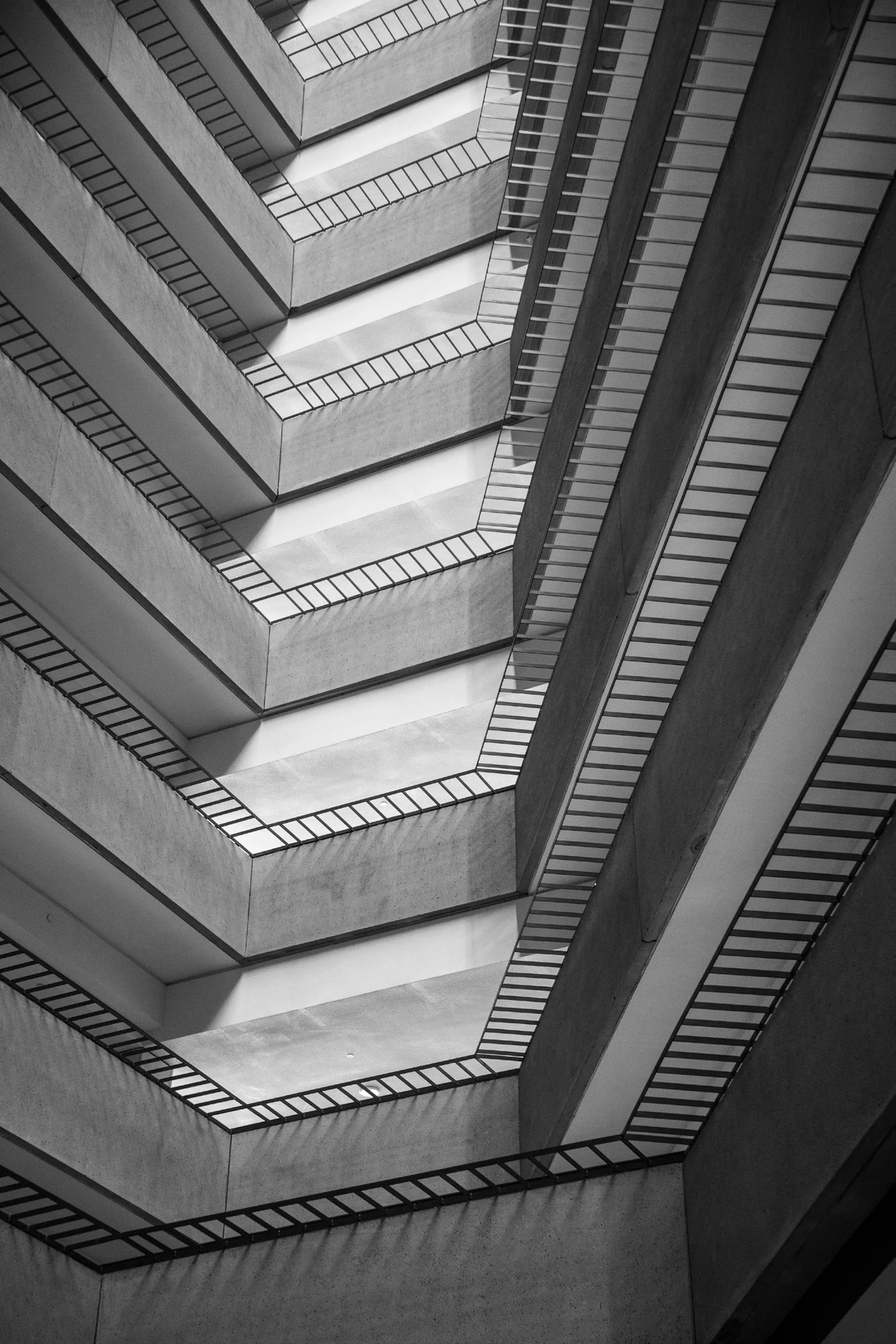 Stairwells with railings make an optical illusion-like pattern