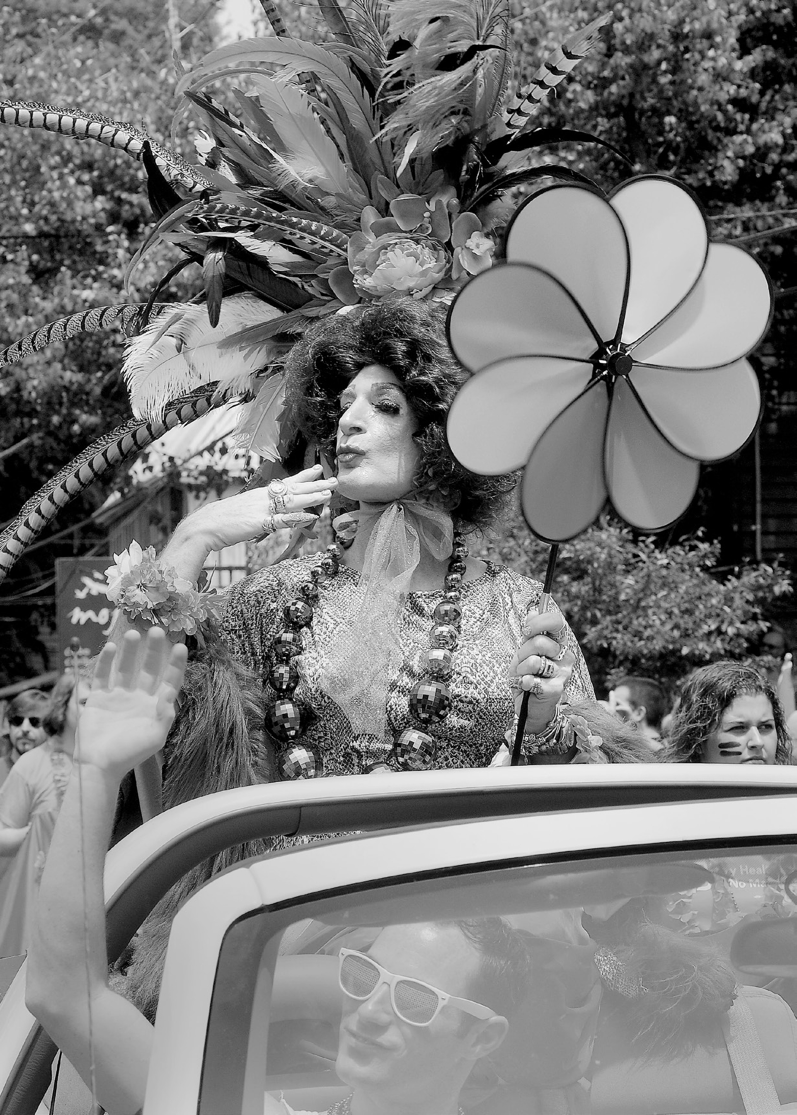 A drag queen in a parade car